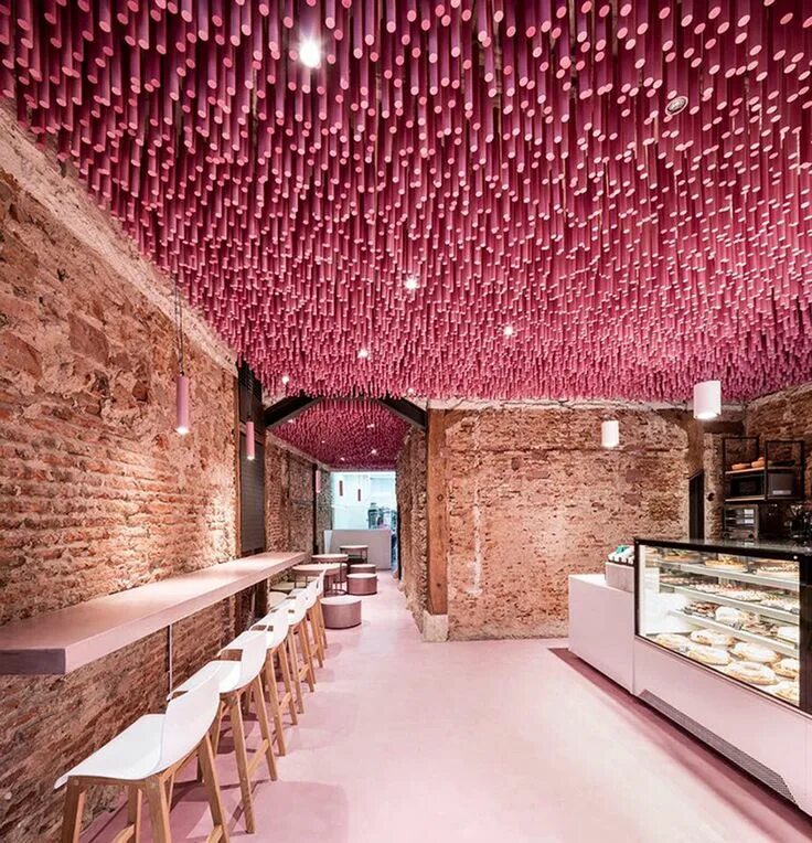 Кафе с необычным интерьером в москве Ideo Arquitectura hangs 12,000 wooden pink sticks from the ceiling of Madrid’s p