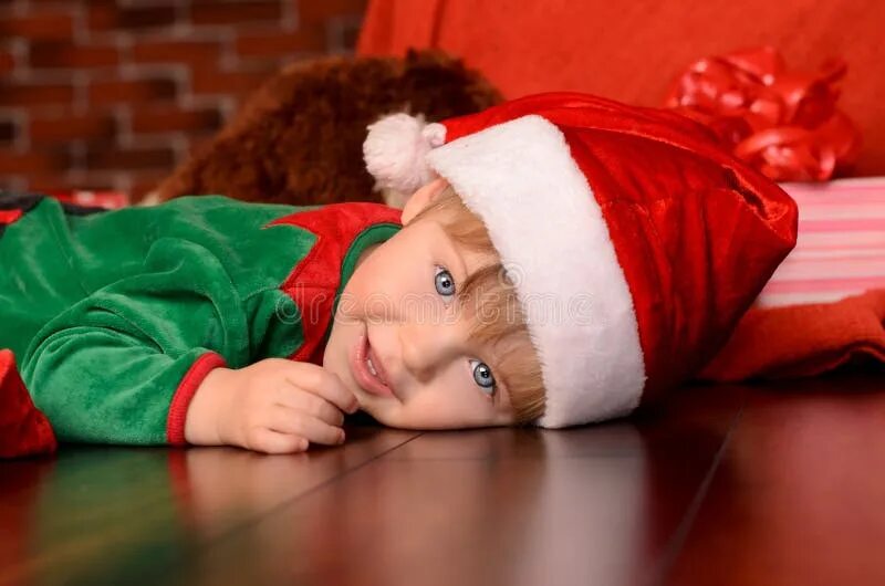 Картинка мальчик новый год Lying Little Boy in Festive Attire Indoors Stock Photo - Image of years, celebra