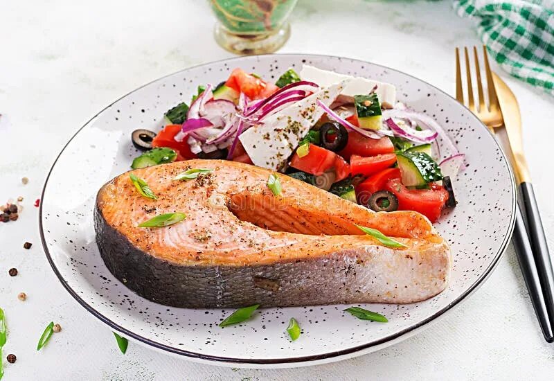 Кето блюда фото Ketogenic Lunch. Baked Salmon Garnished with Greek Salad. Healthy Dinner Stock I