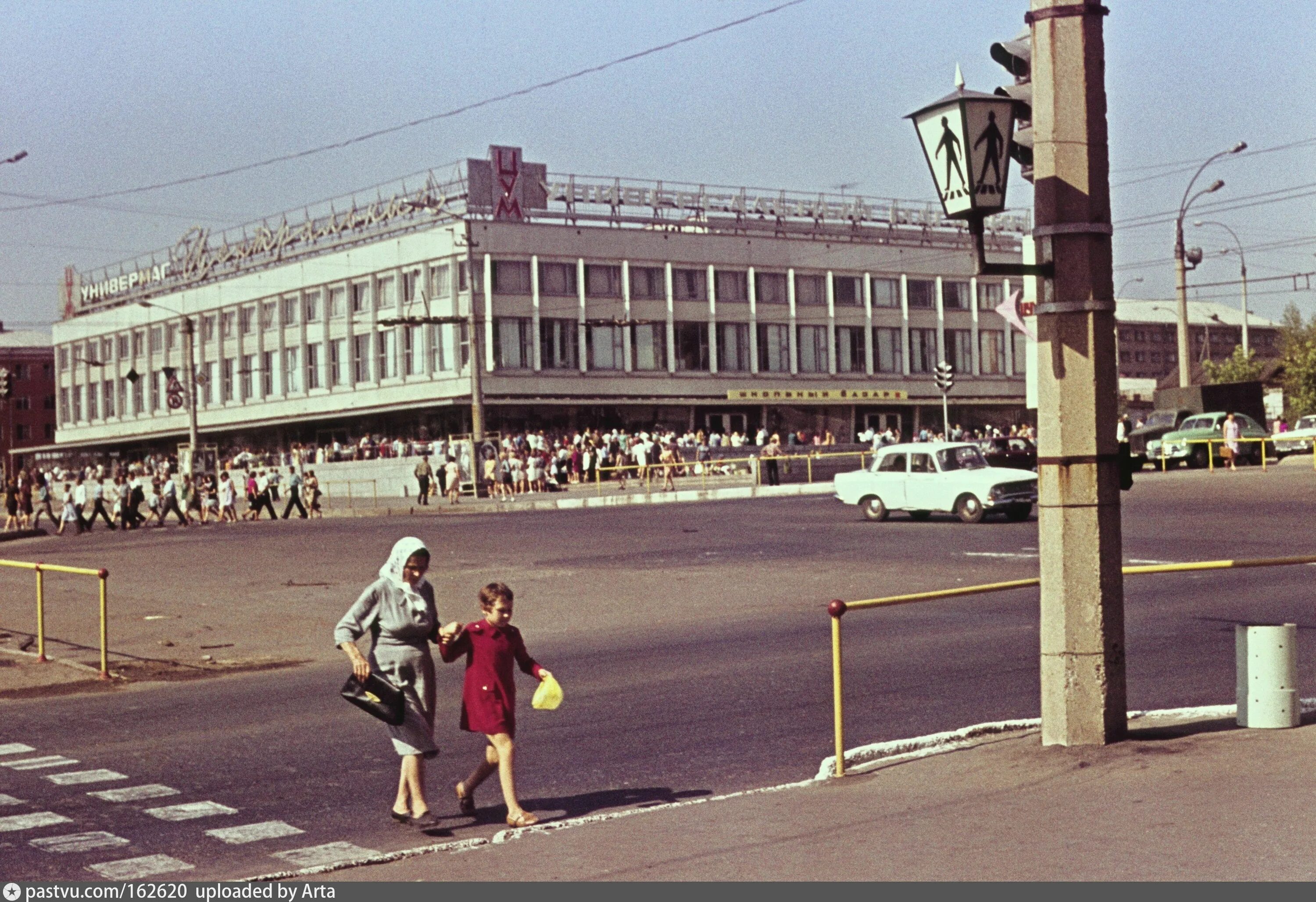 Киров 90 годы фото Two People Crossing the Street in Front of a Building