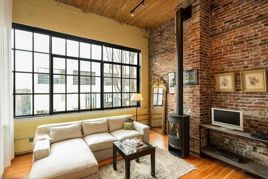 Кирпич в интерьере дома Cozy Living Room with Stunning Fireplace and Brick Walls