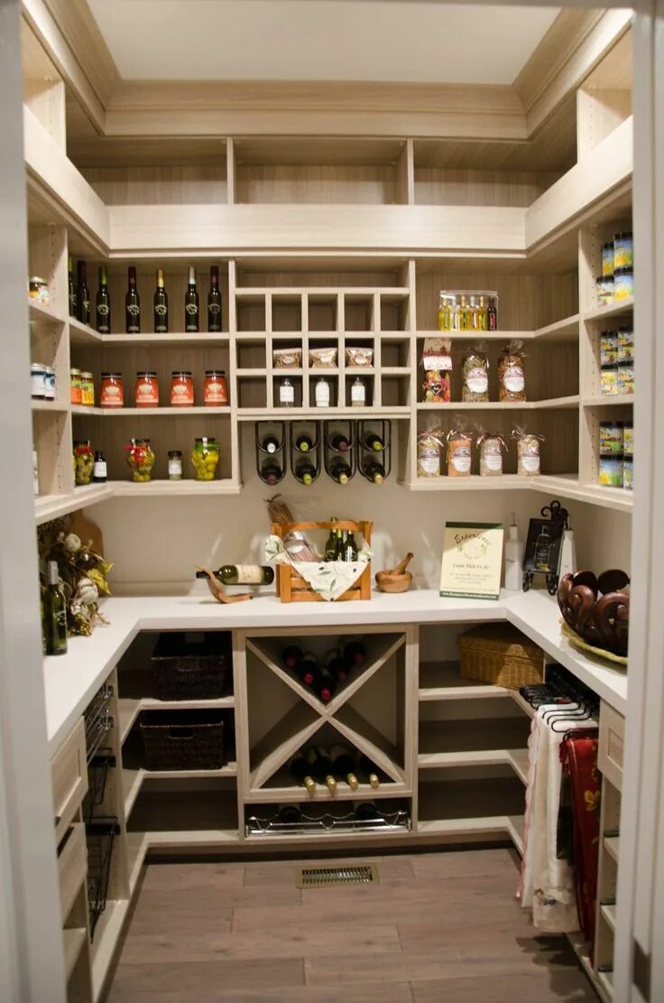Кладовая в частном доме варианты This custom kitchen pantry design features an array of organizational elements, 