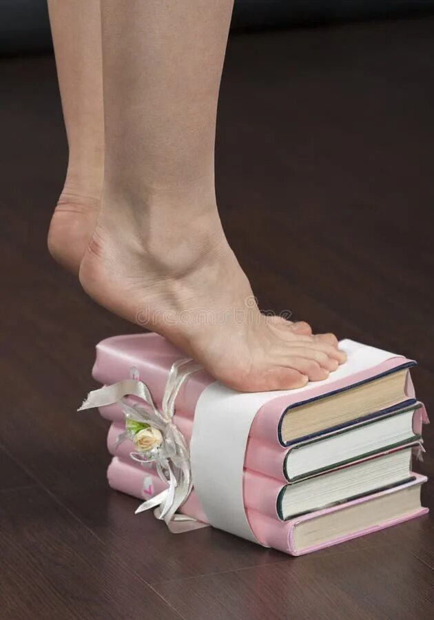 Книга стоп фото Caucasian Female Feet Standing Tiptoe on Stack of Books Closeup Stock Photo - Im