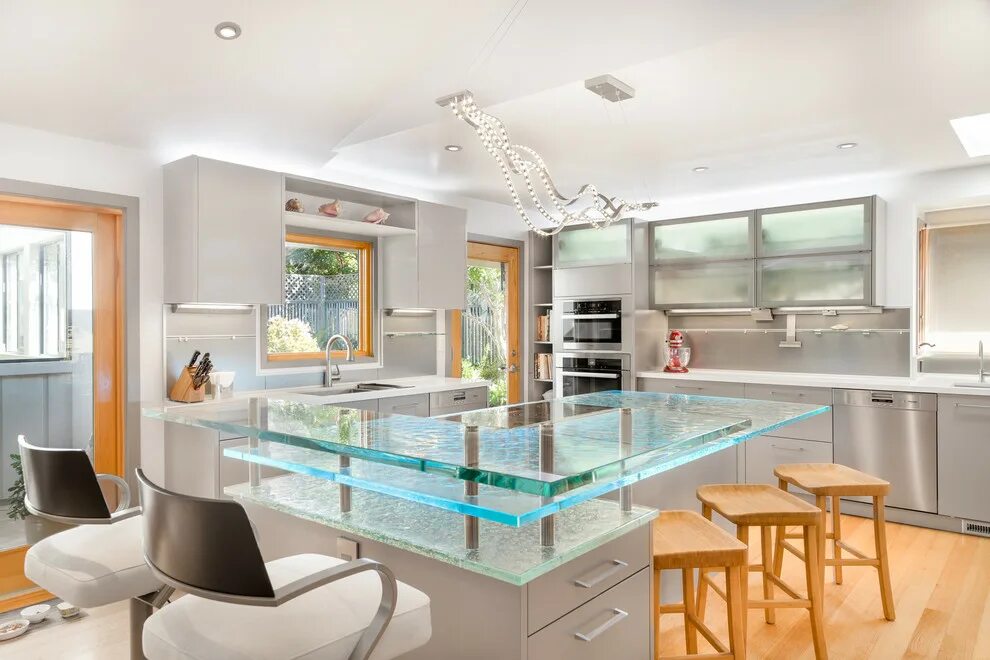 Кухонные стеклянные фото Contemporary kitchen island in California with a raised bar and cast glass count