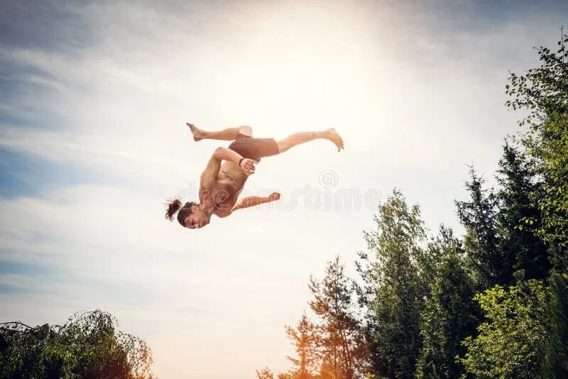 Квадроберы фото людей в прыжке Young Man Doing a Handstand on a Footbride in the Forest. Stock Image - Image of