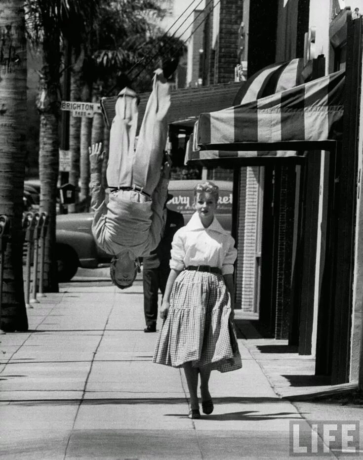 Квадроберы прошлого фото Acrobat and actor Russ Tamblyn does a flip on the sidewalk while walking with mo