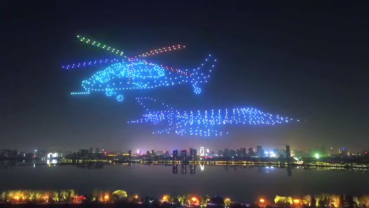 Квадрокоптер ночью в небе фото 800 LED Equipped Drones Fly in the Shape of a Giant Airplane and Other Aircraft 