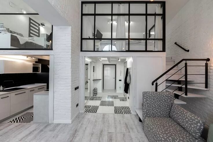 Квартира студия двухуровневая фото This Distinctly Black And White Apartment With A Mezzanine Level Is Home For You