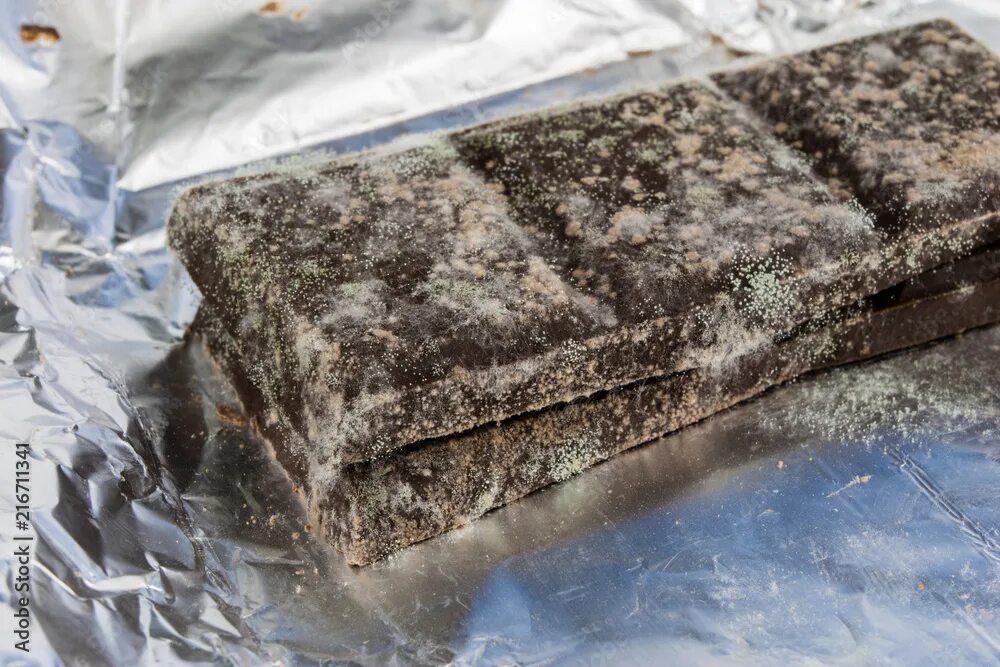 Плесень на шоколаде фото Moldy chocolate in the original packaging. Out-dated food products used for dess