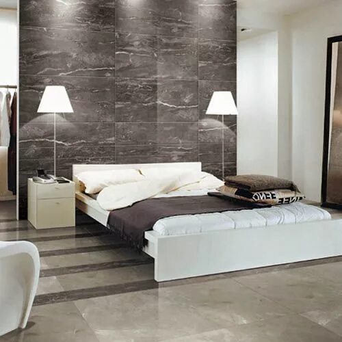 Плитка в интерьере спальни Dark silver marble effect tiles have been used on the wall of this modern bedroo