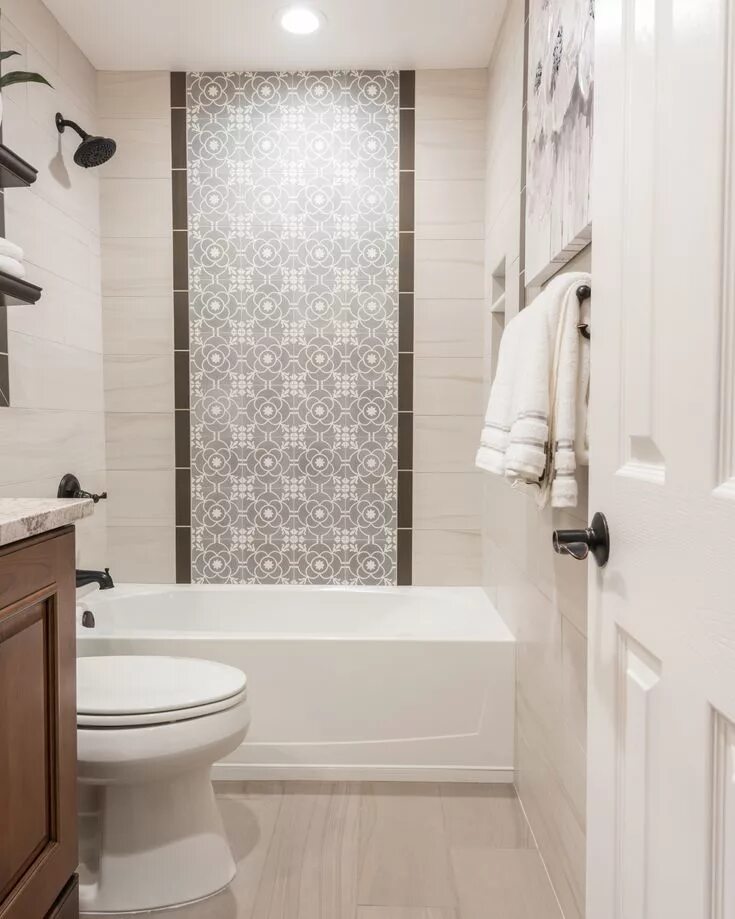 Плитка в маленькой ванной дизайн The shower wall features a center panel with accent tiles from Cement Tile Shop 