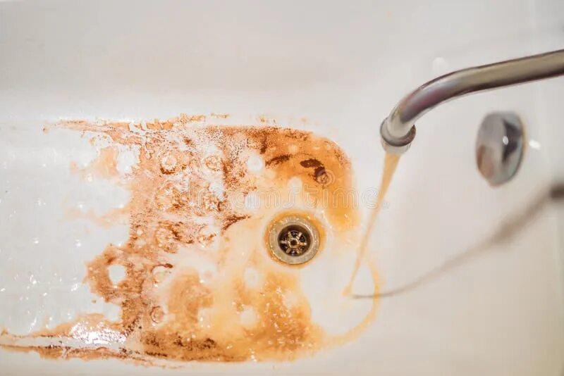 Плохая вода фото Dirty Brown Running Water Falling into a White Sink from Tap. Environmental Poll