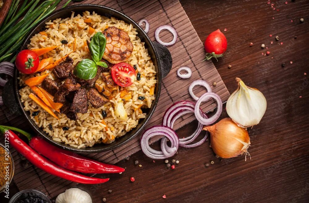 Плов республика крым ялта фото The concept of oriental cuisine. Homemade Uzbek pilaf from lamb served in cast i