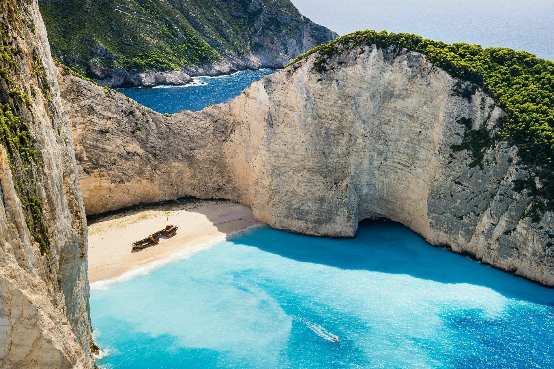 Пляж греция фото Navagio Beach or the Shipwreck is an isolated sandy cove on Zakynthos island and