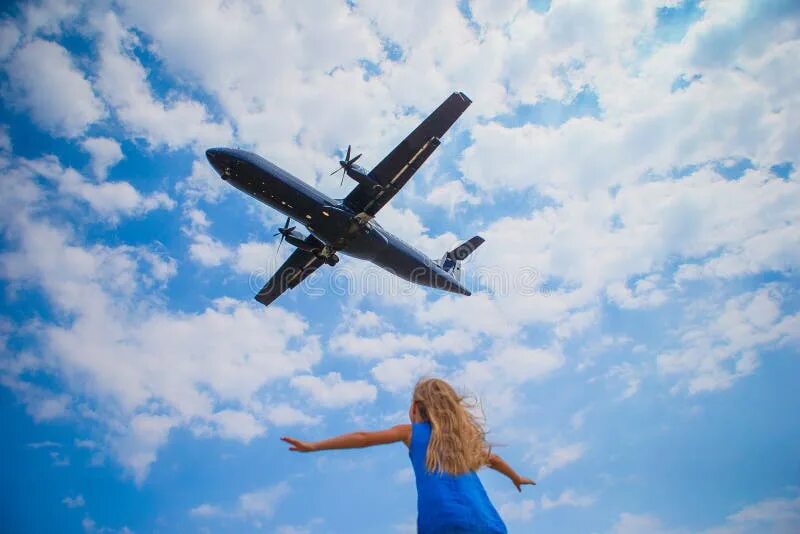 Подпись к фото с самолетом Cute Little Child Girl Looking To the Sky and Flying Plane Directly Above Her St