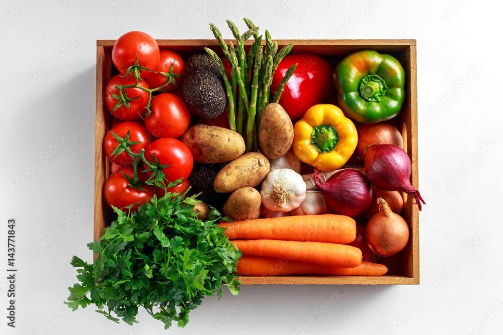 Подписать фото с овощами Fresh Vegetables in wooden box on white wooden background фотография Stock Adobe