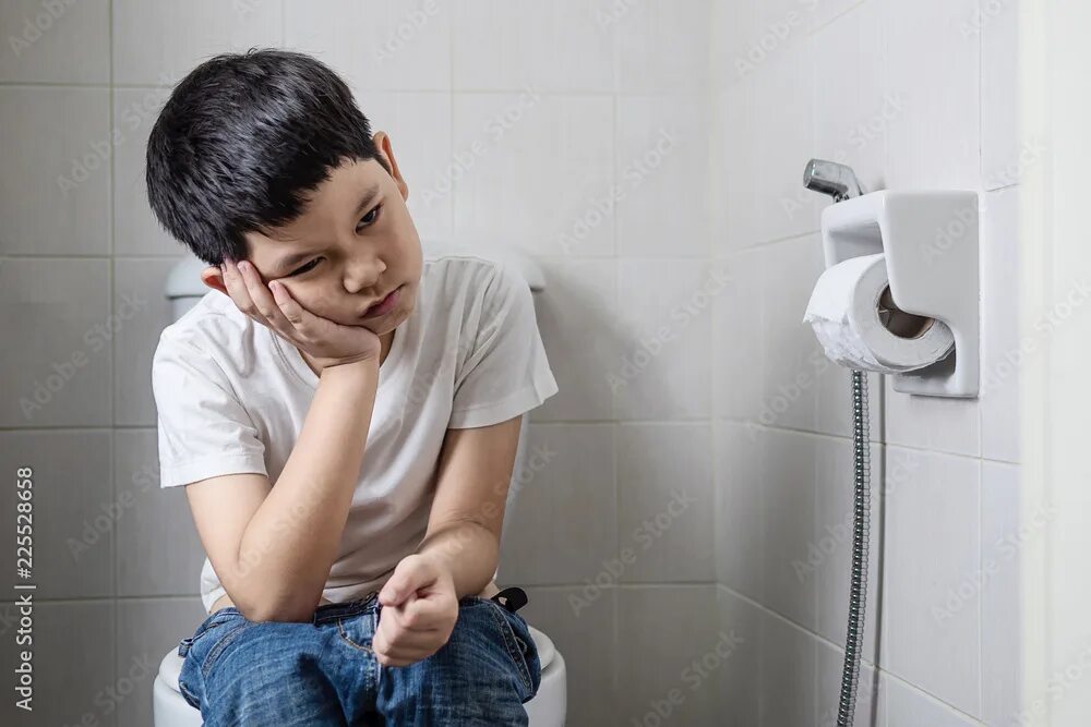 Подростки в туалете фото Asian boy sitting on toilet bowl - health problem concept фотография Stock Adobe