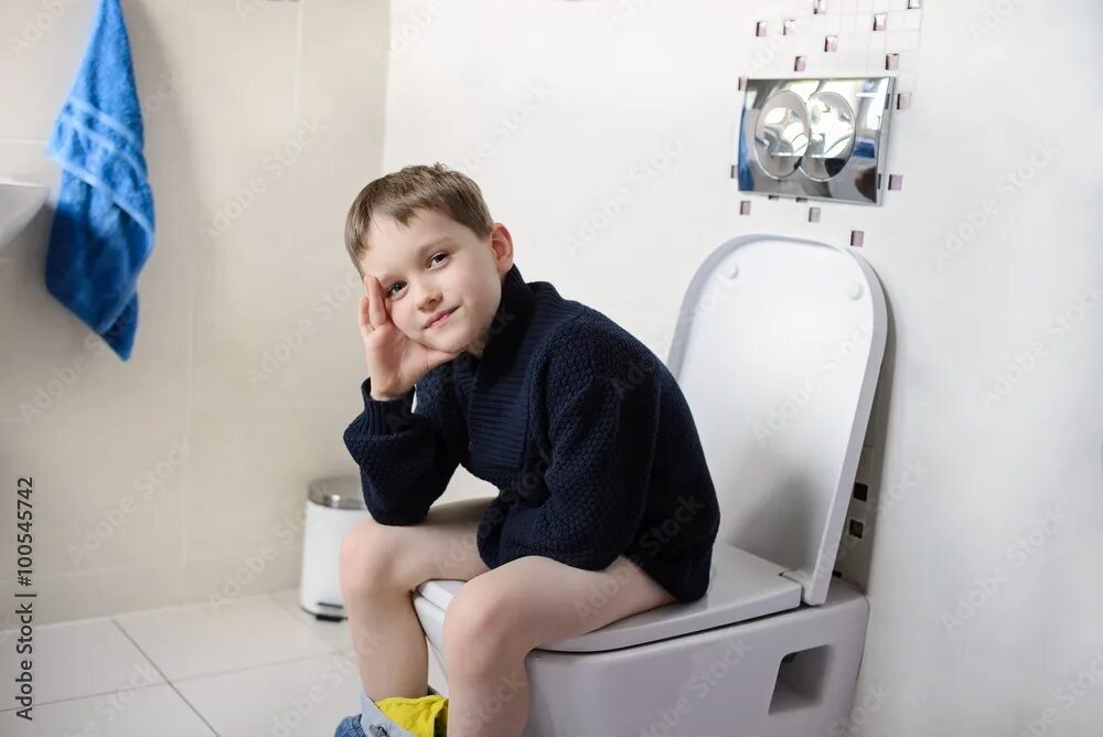 Подростки в туалете фото Thoughtful boy sitting on the toilet. фотография Stock Adobe Stock