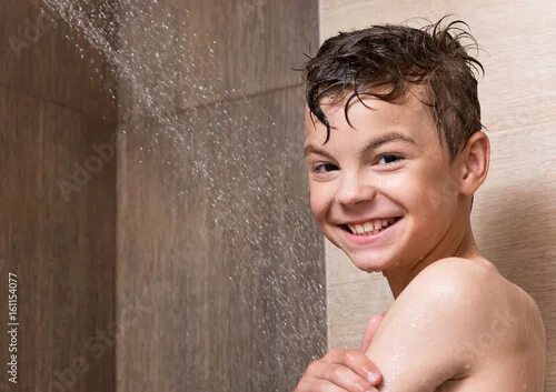 Подростки в ванне фото Portrait of happy teen boy takes a shower in the bathroom, child looking at came