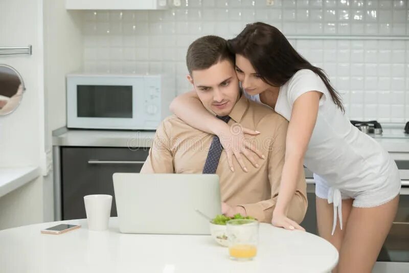 Пока муж на работе фото Man in Formal Wear Working in Kitchen, Woman Embracing Him Stock Photo - Image o