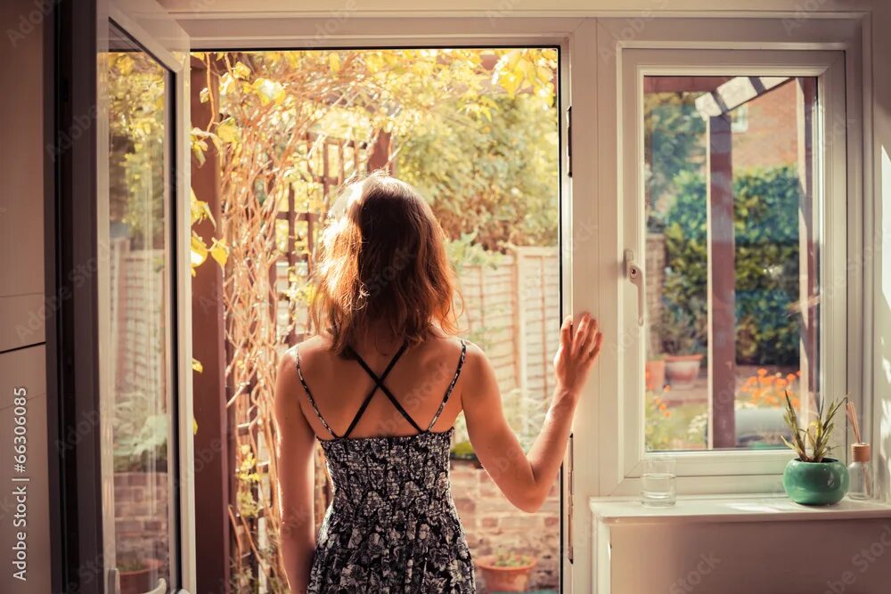 Покажи фото человека за окном Woman standing in doorway at sunrise фотография Stock Adobe Stock