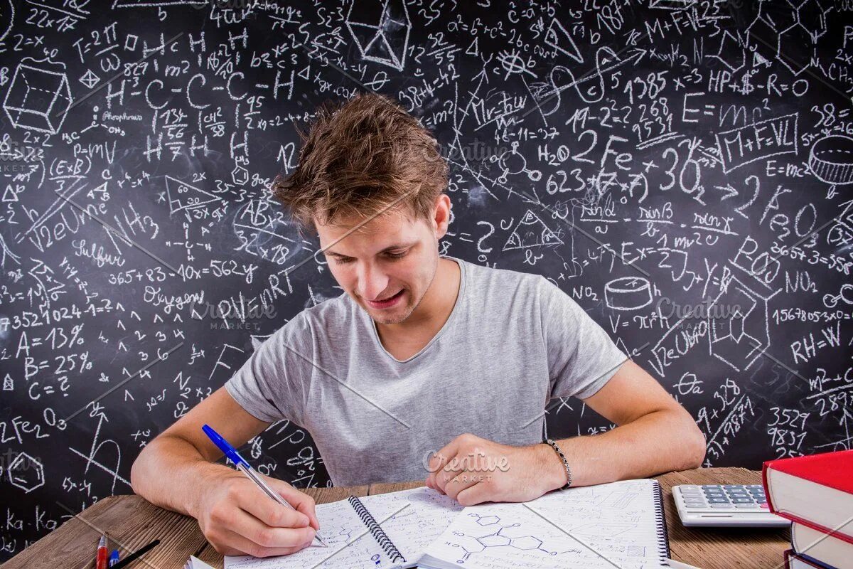 Покажи фото домашняя работа Hipster student doing his homework against a big blackboard featuring Gcse maths