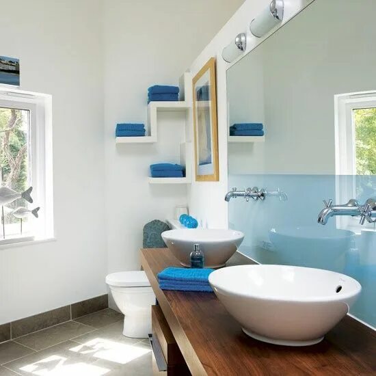 Покрашенная ванная фото a sleek light blue half wall and bright blue towels for a contemporary bathroom 