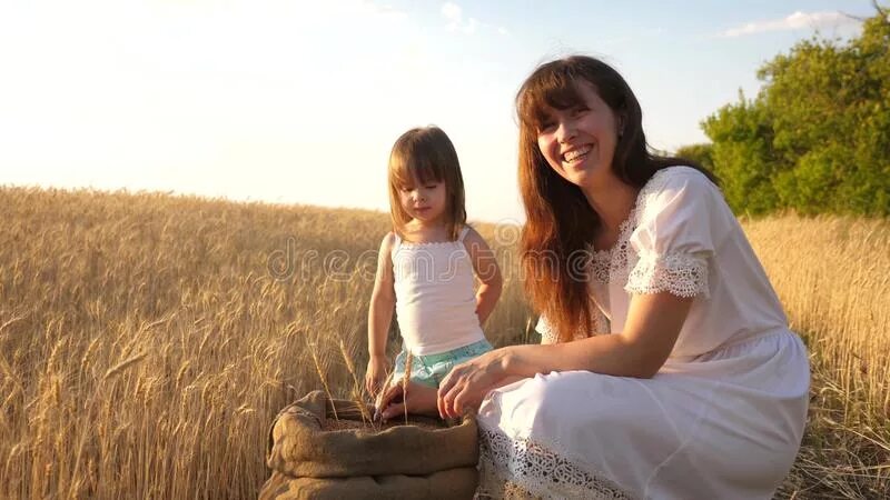 Поли мама фото Mother Farmer is Playing with Little Son, Daughter in Field. Close-up. Ear of Wh