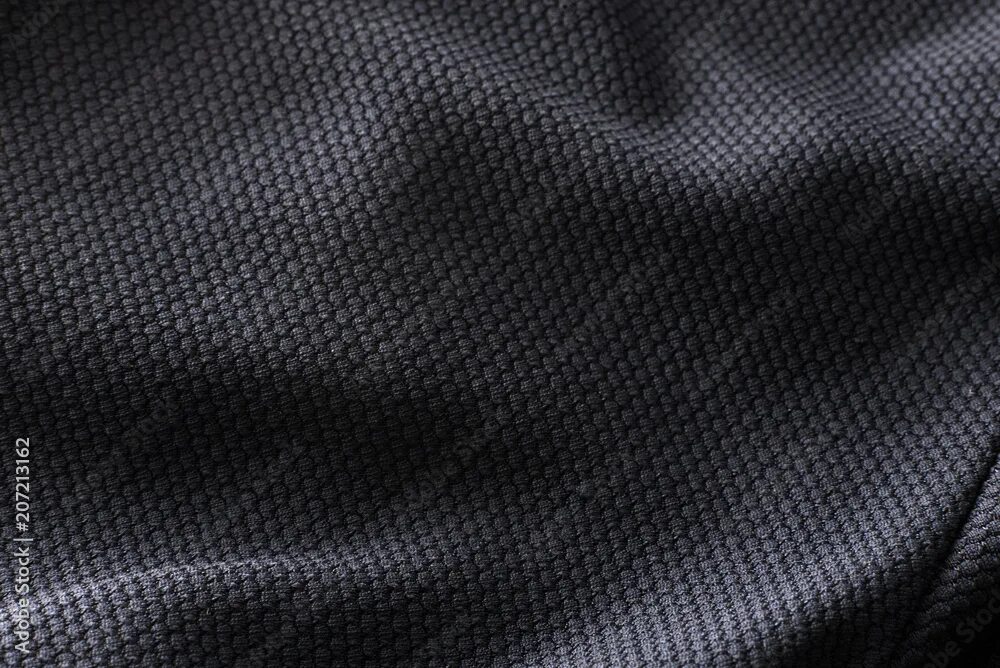 Полиэфирная ткань фото Close-up polyester fabric texture of black athletic shirt фотография Stock Adobe