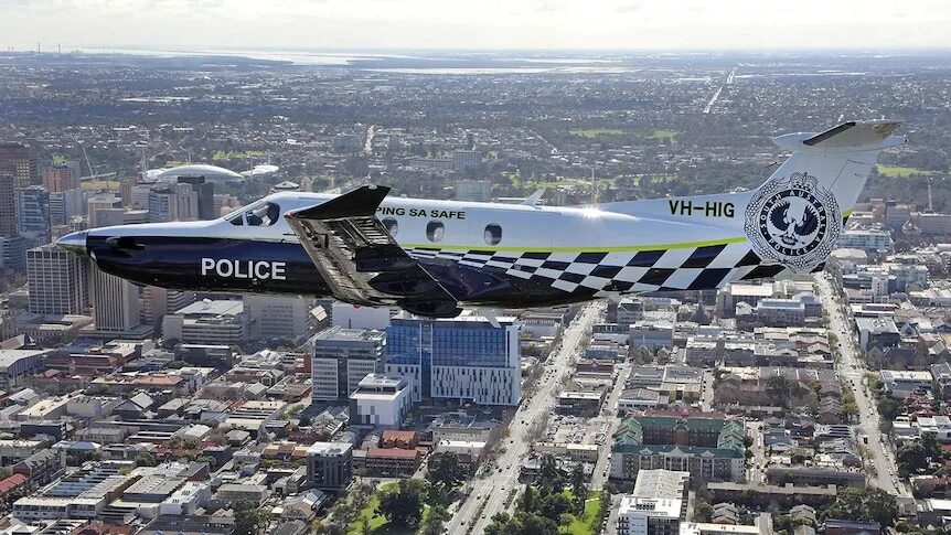 Полицейский самолет фото Police plane 'chased' by helicopter over Adelaide CBD for publicity photo shoot 