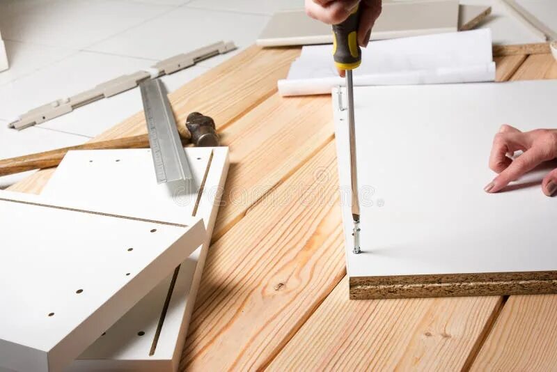 Порядок сборки мебели Assembling Furniture from Chipboard, Using a Cordless Screwdriver Stock Photo - 