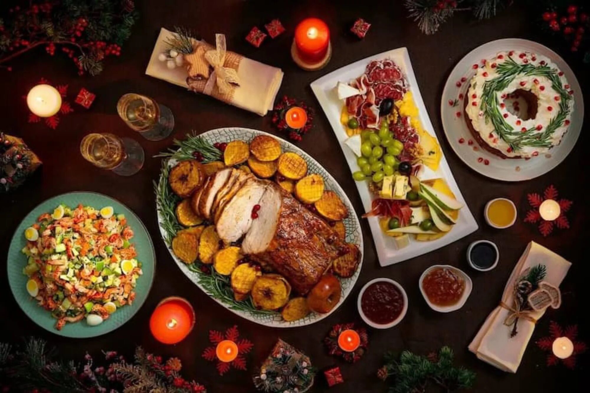 Christmas Dinner table full of dishes with food and snacks, New Year's decor wit