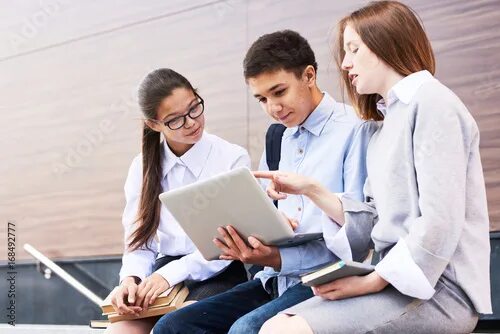 Проектная работа фото Teenage Students Having Project Discussion фотография Stock Adobe Stock