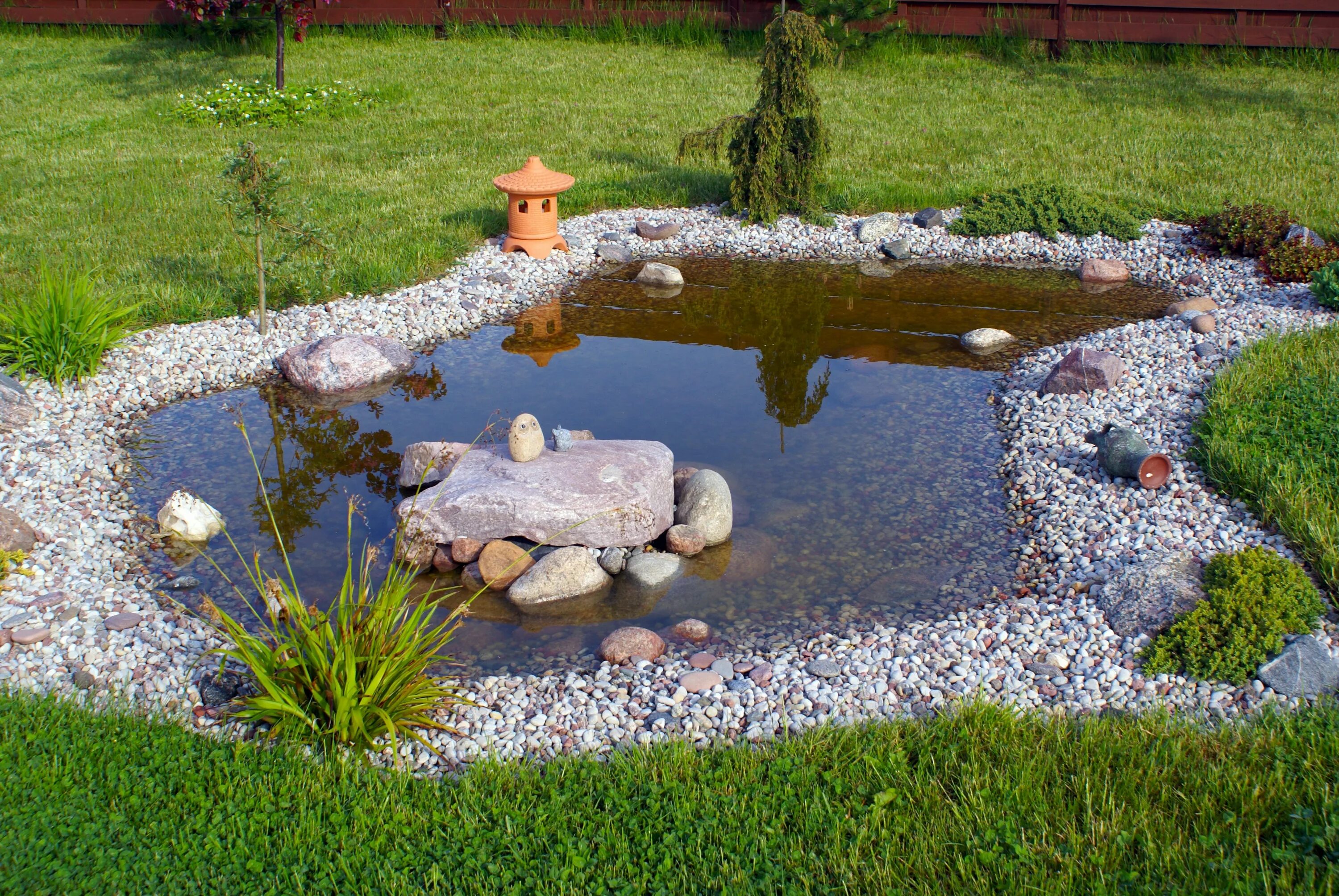 Backyard focal point water garden. This small pond adds interest in the smallest