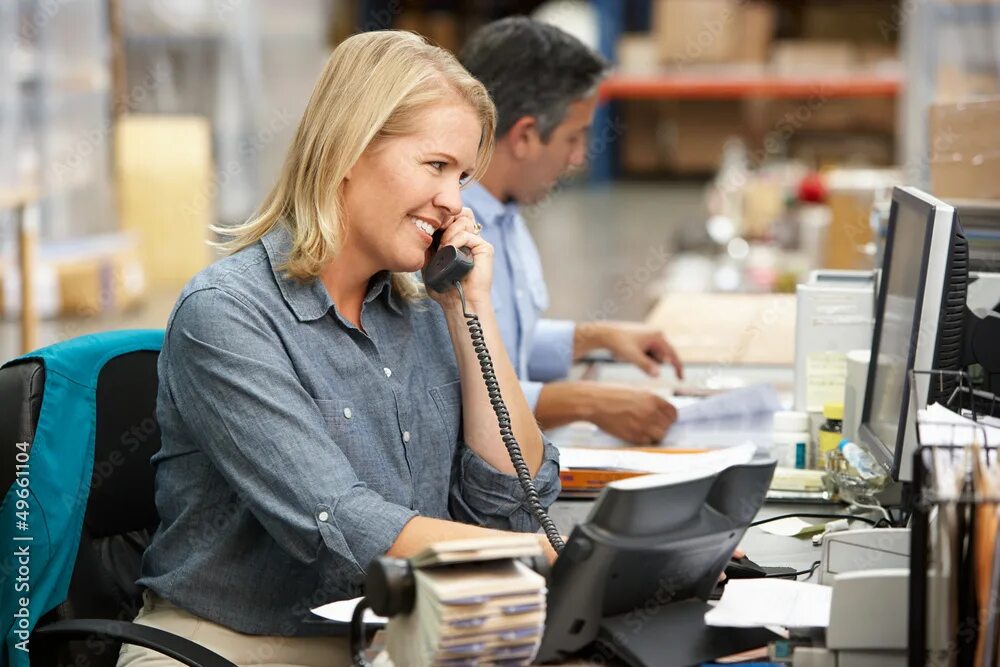 Работа продажа фото Businesswoman Working At Desk In Warehouse фотография Stock Adobe Stock