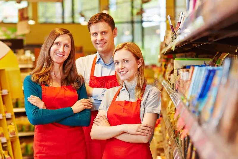 Работа в магазине фото Smiling Sales Team Staff in Supermarket Stock Image - Image of people, employee: