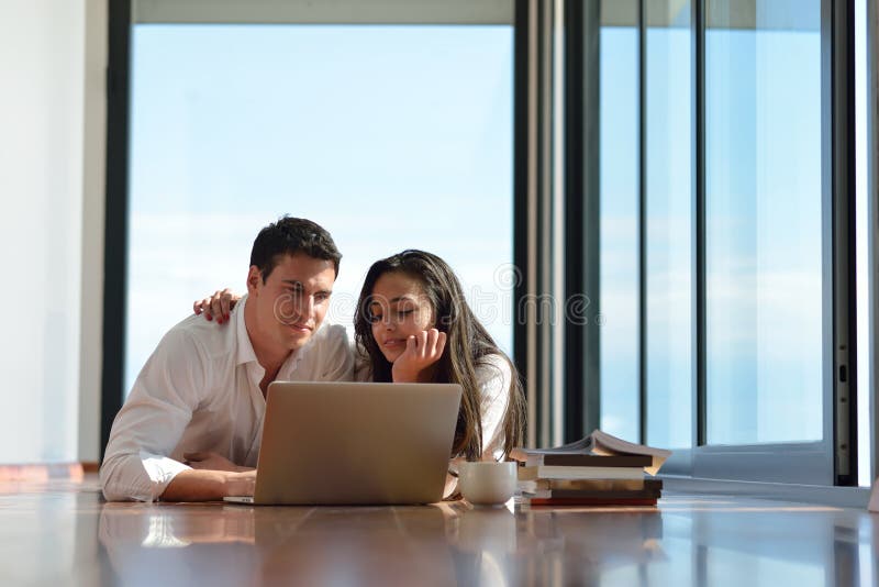 Работа в паре фото Relaxed Young Couple Working on Laptop Computer at Home Stock Image - Image of c