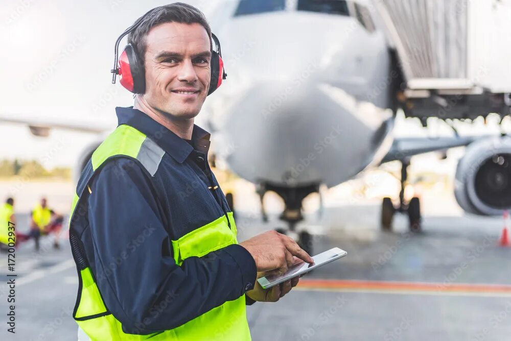 Работники аэропорта фото Happy mechanic having job in airdrome фотография Stock Adobe Stock