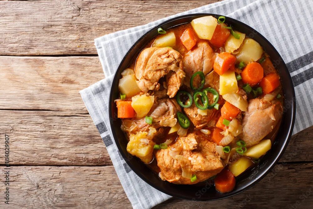 Рагу с курицей фото Korean food: Dakdoritang chicken stew with vegetables close-up on a plate. Horiz