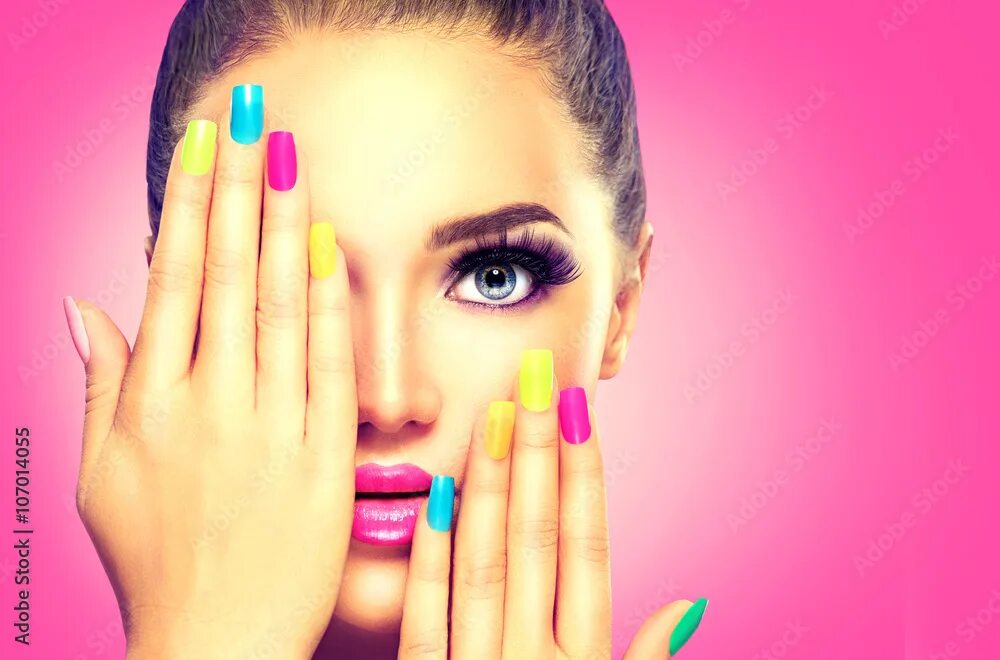 Реклама красивого маникюра Beauty girl face with colorful nail polish Фотографія Stock Adobe Stock