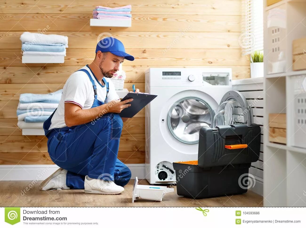 Ремонт бытовой техники фото Working Man Plumber Repairs Washing Machine in Laundry Stock Photo - Image of en