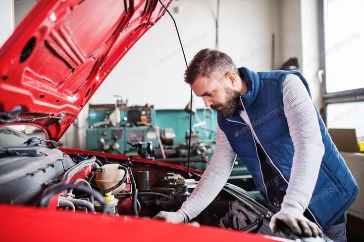 Ремонт машин своими Man mechanic repairing a car in a garage. By halfpoint*`s photos #Ad , #spon, #m