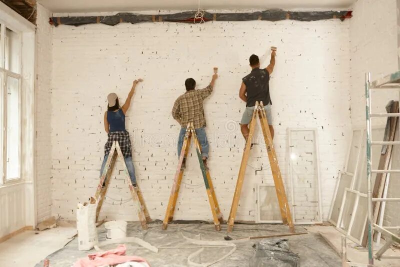 Ремонт стен в квартире своими руками Painters Working on Renovation Site Stock Image - Image of casual, caucasian: 84